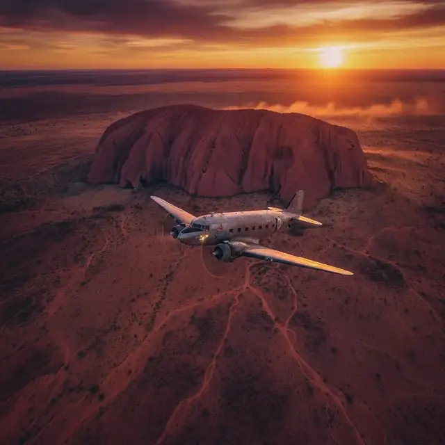 Aircraft over Uluru at sunset
